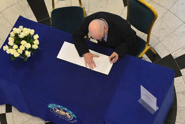 Belfast councillor Billy Hutchinson signs a book of condolences that was opened up for the victims of the Manchester Arena  bomb attack in May 2017