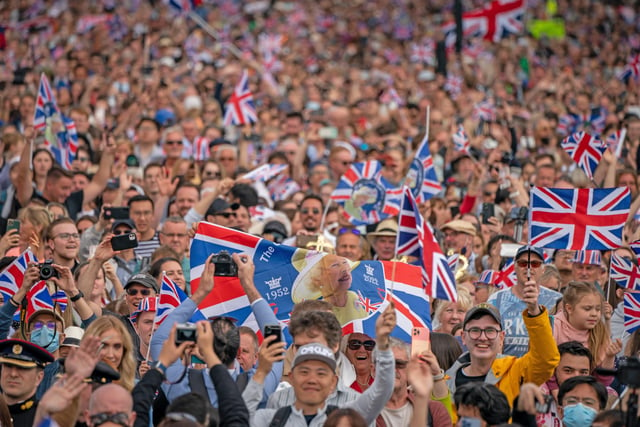 Crowds watch as Queen Elizabeth II makes an appearance on the balcony of Buckingham Palace, to view the Platinum Jubilee flypast, on day one of the Platinum Jubilee celebrations. Picture date: Thursday June 2, 2022.