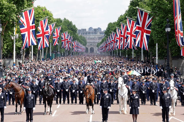 A police line walks members of the public up The Mall towards Buckingham Palace during the Trooping the Colour ceremony at Horse Guards Parade, central London, as the Queen celebrates her official birthday, on day one of the Platinum Jubilee celebrations. Picture date: Thursday June 2, 2022.