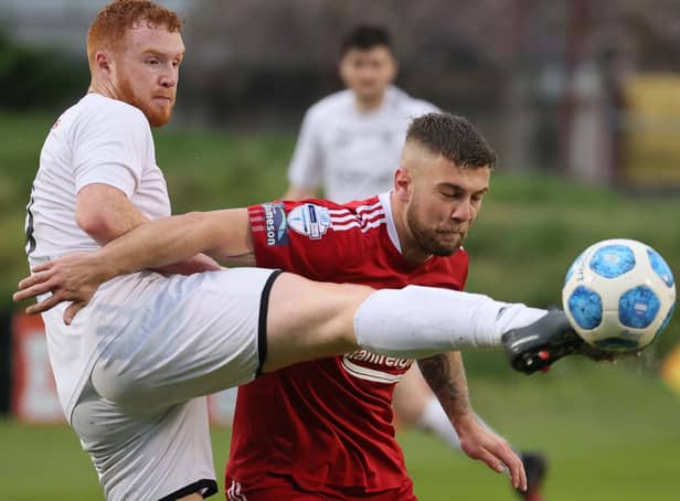 Lee Upton (left) in action against Portadown in the promotion/relegation play-off