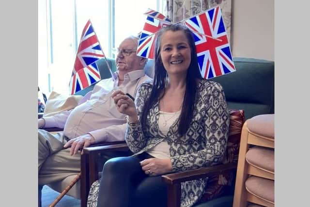 A Queen's jubilee celebration at Abbey Court residents home in East Belfast on Wednesday June 1 2022. Pictured is the home co-ordinator Debbie Spiers, sitting in front of a resident, Jim