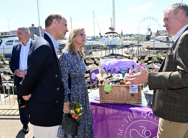 The Earl and Countess of Wessex talk to the NIO minister Conor Burns MP, beside a hamper of Northern Ireland produce, on the pier in Bangor on Saturday. In the background is the marina and a temporary ferris wheel. The royal visitors were cheered by a large crowd on their visit to the seaside city. Jubilee celebrations here follow another big event, when people finally got to mark NI’s centenary.. Photo by Stephen Hamilton / Press Eye