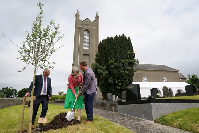 Vestry members Trevor McGaffin (left) Laura McKnight and her husband Neil (right) plant a tree as part of the Queen's Green Canopy initiative during a picnic at St. Bartholomew's Parish Church, Newry, as part of the Big Jubilee Lunch as celebrations continue across Northern Ireland for the Queen's Platinum Jubilee. Picture date: Sunday June 5, 2022.