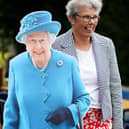 A woman poses for a photo with a cardboard cut-out of Queen Elizabeth II at a picnic at St. Bartholomew's Parish Church, Newry, as part of the Big Jubilee Lunch as celebrations continue across Northern Ireland for the Queen's Platinum Jubilee. Picture date: Sunday June 5, 2022.