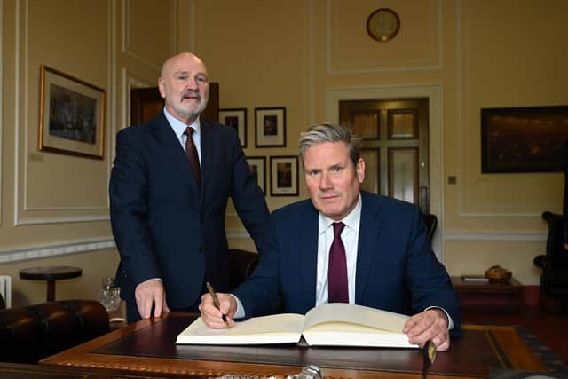 Labour leader Sir Keir Starmer with Alex Maskey, Speaker of the Northern Ireland Assembly, as he signs the Visitor's Book during a visit to Parliament Buildings, Stormont, on Friday