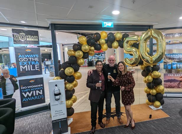 Dougie Muir, manager with customers John Momville and Donnah Momville enjoy the anniversary celebrations at the Belfast branch
