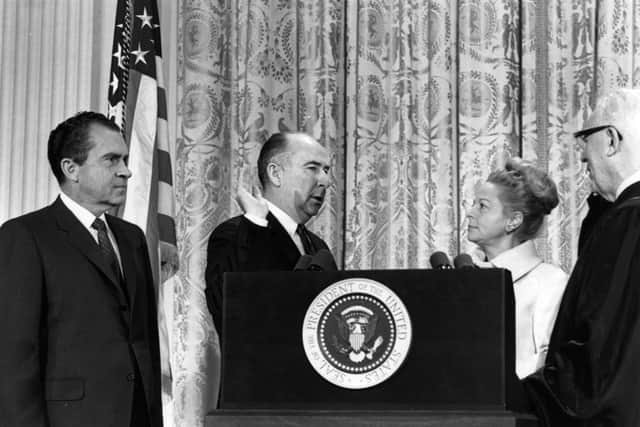 John Mitchell, one of Richard Nixon’s top aides who faced charges in connection with the Watergate scandal, is sworn in at the Senate. His wife Martha is second from right. President Nixon is on the left.  Photo by Keystone/Getty Images)
