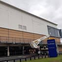 The old Debenhams sign at Rushmere Shopping Centre in Craigavon, Co Armagh is removed by workmen today.