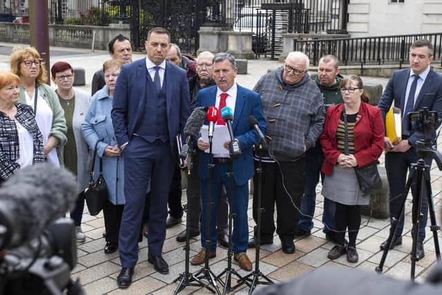 John Teggart (centre), son of Ballymurphy victim Daniel Teggart, speaks with media outside the Crown Court in Belfast on Monday