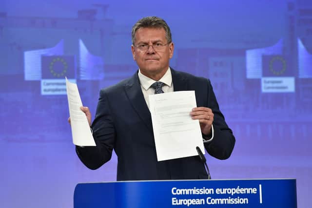 European Commissioner Maros Sefcovic holds up documents as he speaks during a media conference at EU headquarters in Brussels on Wednesday