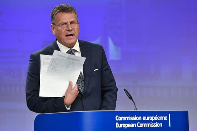 European Commissioner for Inter-institutional Relations and Foresight Maros Sefcovic holds up documents as he speaks during a media conference at EU headquarters in Brussels, Wednesday, June 15, 2022
