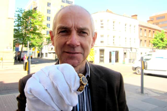 One of two gold rings found by Brian Murray of Newtownards held by Dr Greer Ramsey of National Museums NI