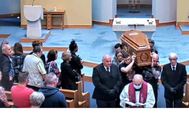 The coffin of Glenn Finlay leaving the chapel, taken from a live public broadcast of the funeral