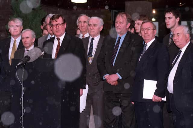 Ulster Unionist party leader David Trimble, backed by his negotiating team, announce to the gathered media that the Belfast Agreement had been signed in 1998