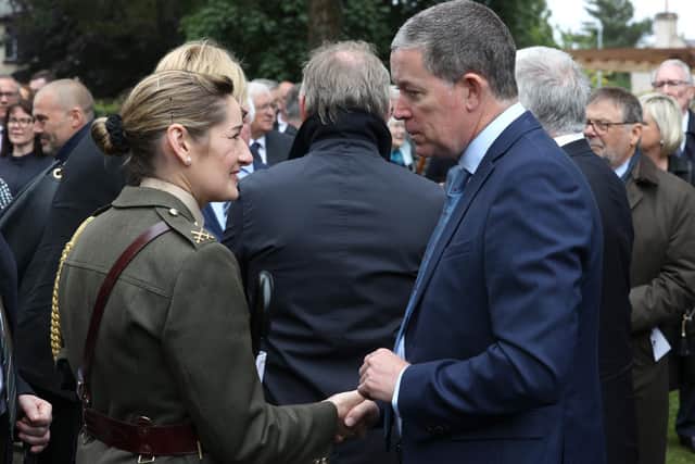 Commandant Claire Mortimer (left) Aide De Camp representing the Taoiseach talking to Dominic Fitzpatrick (right), son of James Fitzpatrick at the funeral of his father and long-time owner of the Irish News newspaper, at St Brigid's Parish Church, Belfast.
