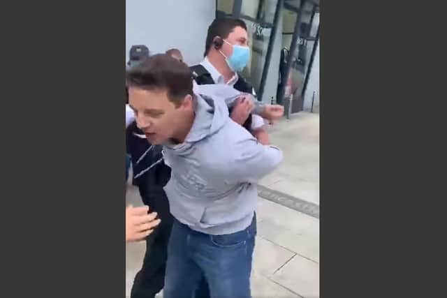Gospel preacher Ryan Williamson, 44, is arrested by PSNI officers for suspected disorderly behaviour after refusing to stop preaching in Larne town centre in August 2021. He was dearrested 30 minutes later and went back to preaching.