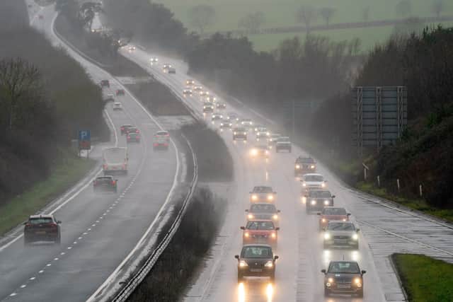Cars make their way through heavy rain