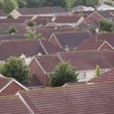 The average UK house price hit a new record high in June but there are "tentative signs of a slowdown", according to an index.
