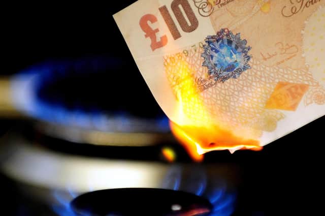 File photo dated 22/04/12 of a £10 note burning on a gas hob. Photo credit: Rui Vieira/PA Wire