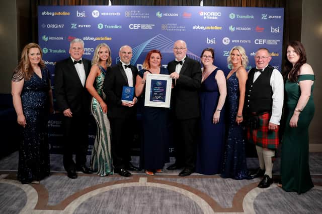 Managing director Keith Toner and his team collecting their award