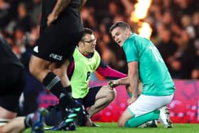 Johnny Sexton receives medical attention during the first test match against the All Blacks