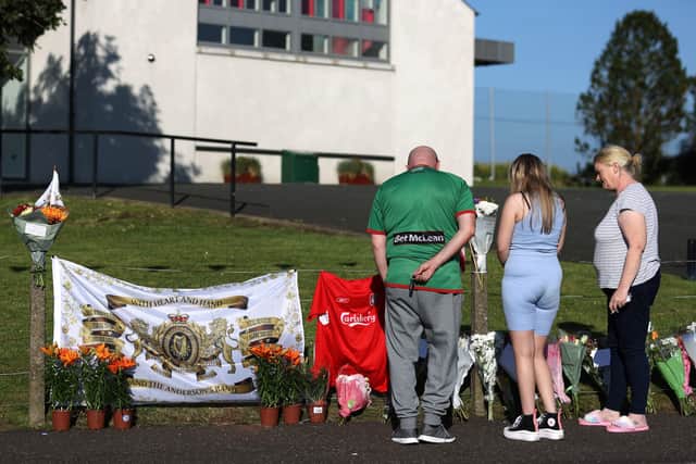 Flowers near the scene after a man died after falling from a bonfire on the Antiville estate in Larne, Co Antrim on Saturday night. Photo: Liam McBurney/PA Wire