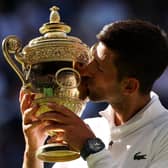 Novak Djokovic kisses the Men’s Singles trophy following his victory against Nick Kyrgios