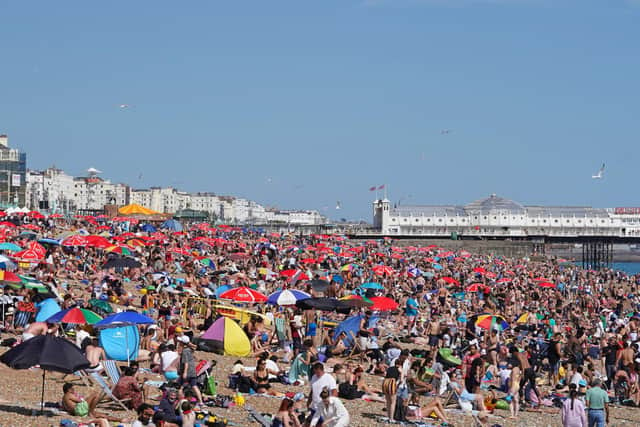 People enjoy the warm weather at Brighton beach in West Sussex on Sunday. The temperature in the south of England reached almost 30 Celsius, 85F. Photo: Gareth Fuller/PA Wire