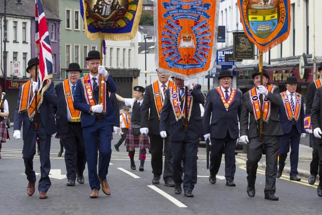 The Rev Mervyn Gibson (second left) at the head of the parade as it made its way through Newry