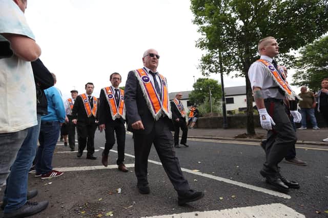 Members of a Protestant loyalist order, Pride of Ardoyne, walking past Twaddle Avenue, as they take part in a Twelfth of July parade in Ardoyne, Belfast, as part of the traditional Twelfth commemorations marking the anniversary of the Protestant King William's victory over the Catholic King James at the Battle of the Boyne in 1690.
