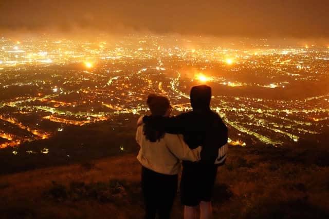 A view from Cavehill overlooking Belfast city of loyalist bonfires burning as part of the traditional Twelfth commemorations. Picture: Niall Carson/PA Wire