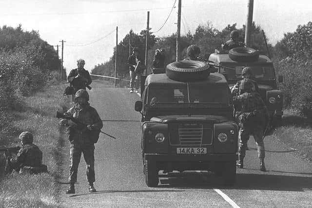 Soldiers operate a security cordon on the Ballygawley to Omagh road in August 1988 after three IRA members were shot dead by the SAS. Photo: Pacemaker Belfast