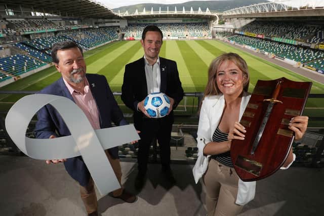 Tahnee McCorry and Ian Allen of White Ribbon NI pictured with the NIFL Charity Shield alongside Neil Coleman of the NI Football League