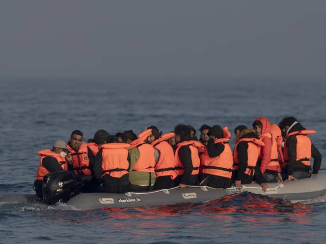 An inflatable craft carrying migrant men, women and children crosses the shipping lane in the English Channel. (Photo by Dan Kitwood/Getty Images)