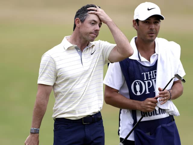 Northern Ireland's Rory McIlroy (left) looks dejected after finishing his round on the 18th green with caddie Harry Diamond during day four of The Open at the Old Course, St Andrews. Pic by PA