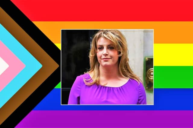 Penny Mordaunt and the LGBTQQIA+ flag with added transgender and BLM stripes
