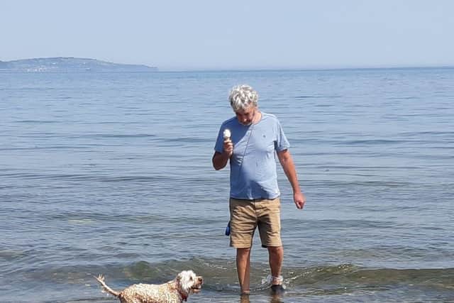 Paul Bell and his dog Teddy cool off in the sea