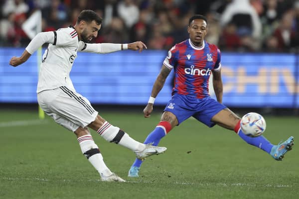Manchester United's Bruno Fernandes (left) kicks the ball past Crystal Palace's Nathaniel Clyne during a pre-season game between Manchester United and Crystal Palace at the Melbourne Cricket Ground in Australia. Pic by PA.