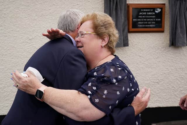 Daughter of bus driver Jackie Gibson Lynda Van Cuylenburg hugs her brother Robert Gibson, at an event with some of their father's former colleagues in Ulsterbus and current drivers to unveil a plaque at the depot in Ballygowan where he began his journey on Bloody Friday. Jackie was killed in the bomb that detonated at the Oxford Street bus station on July 21 1972. Picture date: Thursday July 21, 2022.