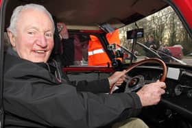 Paddy Hopkirk in the driving seat of a 1964 Mini in 2014