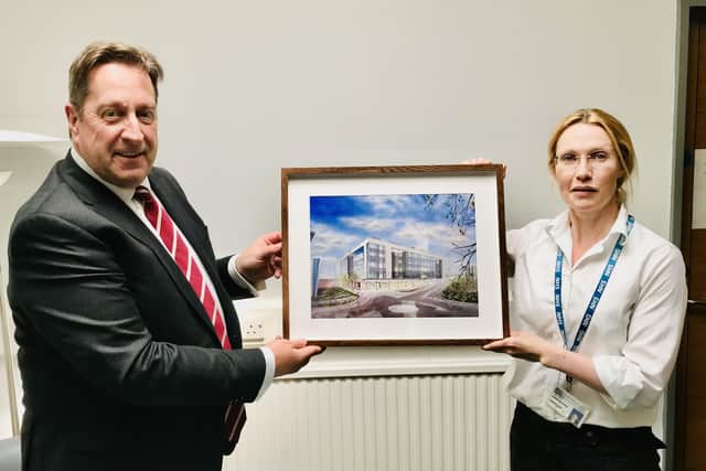 South Eastern Health Trust chairman Jonathan Patton is presented with his painting by respiratory consultant physician, Dr Jennifer Elder