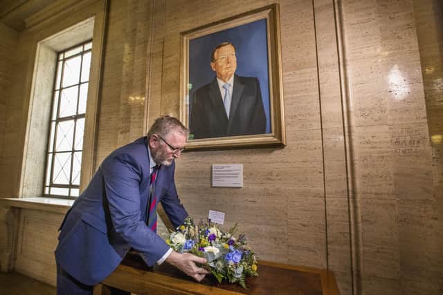Doug Beattie, leader of the Ulster Unionist Party (UUP) lays a wreath under the portrait of the party's former leader David Trimble, in the Great Hall of Parliament Buildings at Stormont, expressing condolences to the family of Mr Trimble who died on Monday. Books of condolence are opening across Northern Ireland in memory of former first minister David Trimble