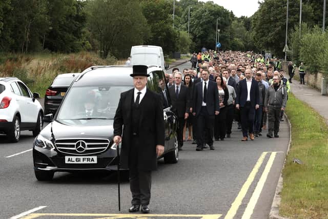 Employees and family follow the cortege ahead of the funeral service for the founder of WireWrightbus, Sir William Wright in Ballymena. Picture date: Wednesday July 27, 2022.