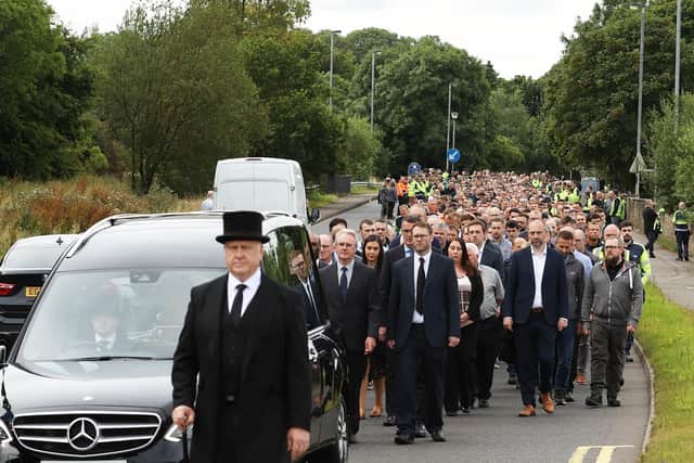 Employees and family follow the cortege ahead of the funeral service for the founder of WireWrightbus, Sir William Wright in Ballymena. Picture date: Wednesday July 27, 2022.