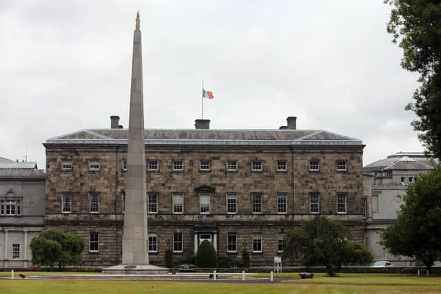 The Irish flag flies at half mast at Leinster House in Dublin. Photo credit: Niall Carson/PA Wire