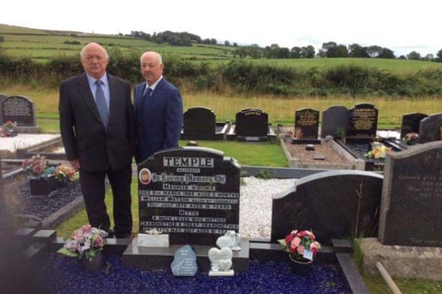 Brothers David and Adrian Temple, at the grave of William Temple who was killed in the Claudy bombing