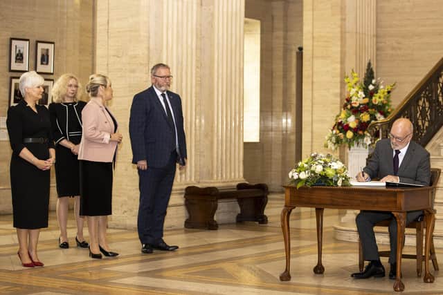 (left to right) DUP MLA Joanna Bunting, Clerk/Chief Executive of the Northern Ireland Assembly Lesley Hogg, Sinn Fein Vice President Michelle O'Neill and UUP leader Doug Beattie MLA look on as the Assembly Speaker Alex Maskey writes a message in the book of condolence, in the Great Hall of Parliament Buildings at Stormont for former Northern Ireland First Minister and leader of the Ulster Unionist Party (UUP) Lord David Trimble, who died last week aged 77. Picture date: Tuesday August 2, 2022.
