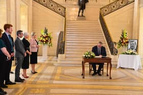 UUP leader Doug Beattie signing the Book of Condolence at Stormont