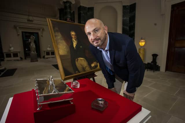 Dr Christopher Warleigh-Lack, National Trust property curator looks at an inkstand and inkwells belonging to Viscount Castlereagh which are on display at his former home, Mount Stewart in Newtownards, which opens an exhibition on his life and legacy, in the 200th year since his death.