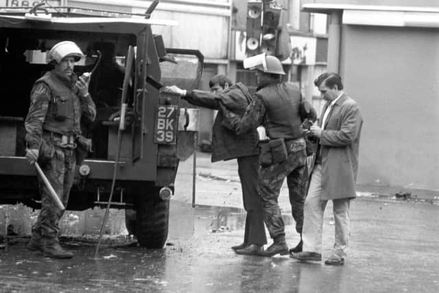 Soldiers conduct searches of people entering Londonderry after clearing barricades from the Bogside and Creggan in Operation Motorman in 1972.